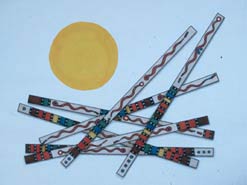 Seven long rectangular shapes with light blue bodies, embellished patterns of dots and stripes in red, dark blue, black and yellow criss-cross each other in a random fashion, occupying the about two thirds of the painting's foreground in the center, right side and bottom. Slightly above and to the left of center is a large yellow orb.